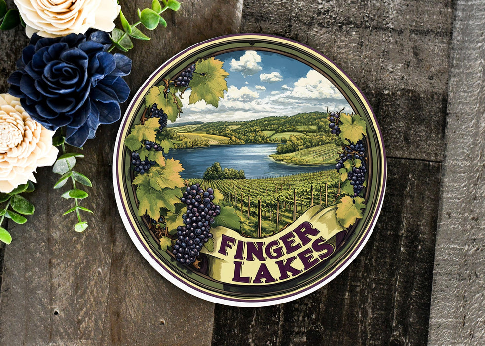 a tint tin with a painting of a lake surrounded by flowers