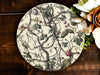 a white plate with a tree design on it