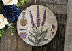 a plate with flowers and herbs on it