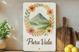 a sign that says pura vida with a picture of a volcano in the