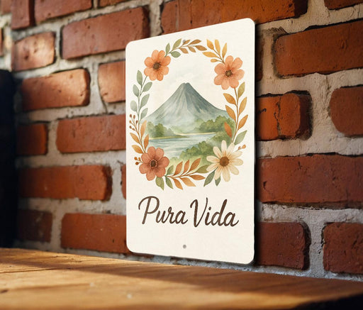 a sign that says pura vida on a brick wall