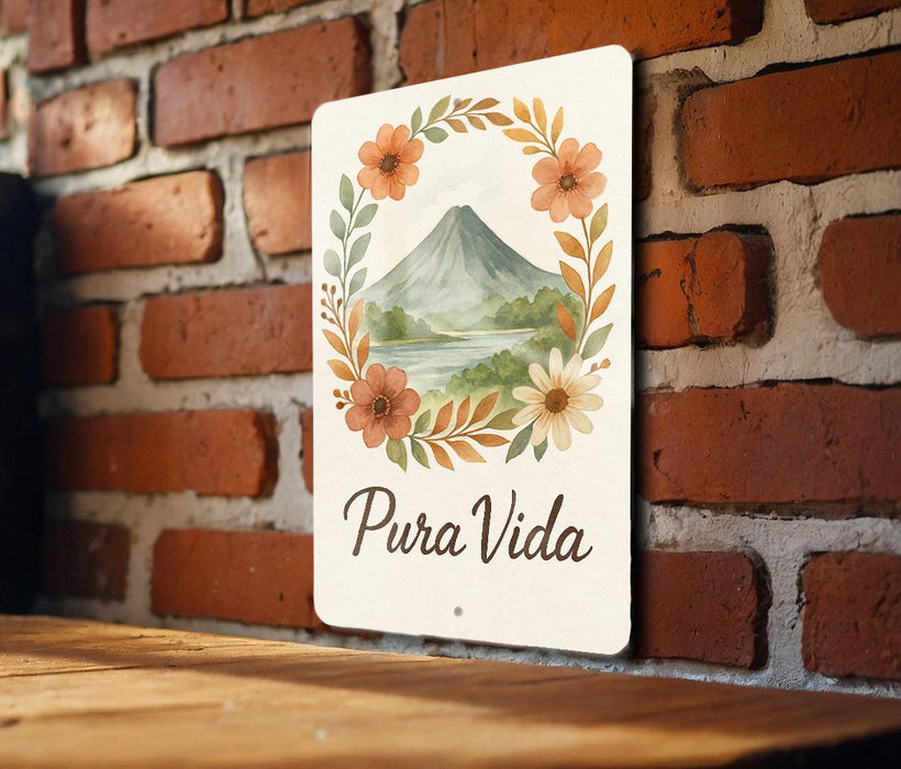 a sign that says pura vida on a brick wall
