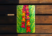 a painting of flowers on a wooden bench