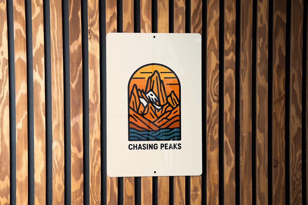 a sign on a wooden wall that says chasing peaks