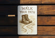 a sign on a wooden bench that says walk your path
