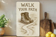 a sign that says walk your path next to a potted plant