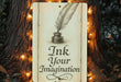 a sign with a feather quill on it next to a tree