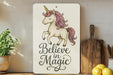 a wooden sign that says believe in magic with a unicorn on it