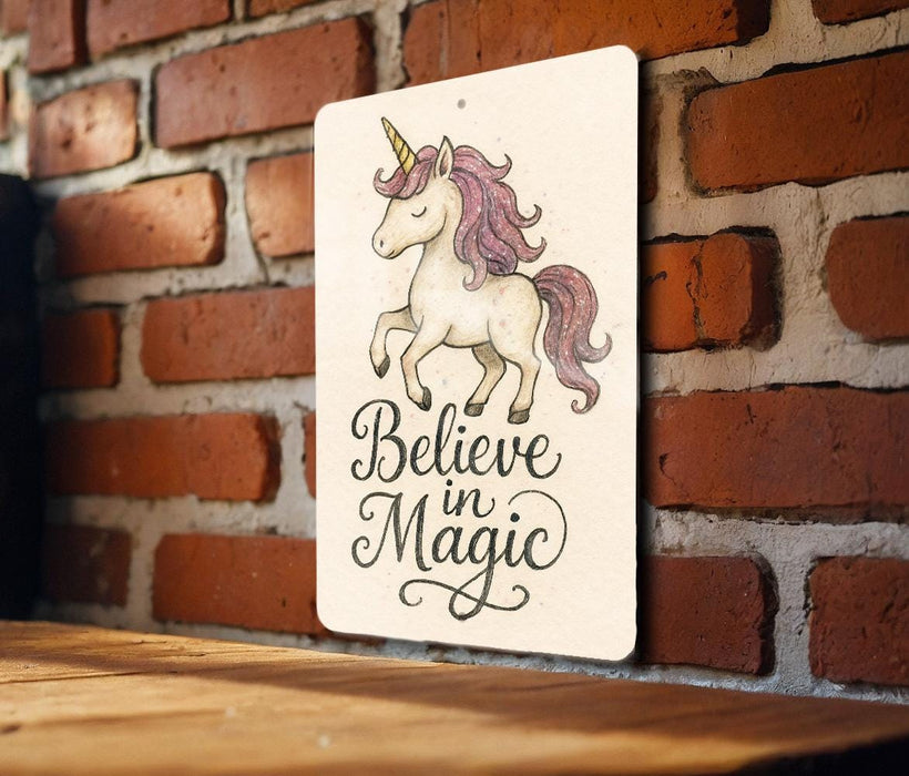 a wooden sign that says believe in magic on a brick wall