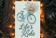 a sign that says life's a ride on a bicycle