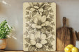 a picture of a flower on a wall next to a cutting board