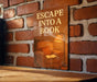 a sign that reads escape into a book on a brick wall