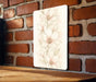 a picture of a white flower on a brick wall