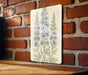 a picture of some flowers on a brick wall