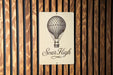 a sign on a wooden wall that says soar high