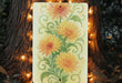 a painting of flowers is hanging on a tree