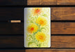 a painting of yellow and orange flowers on a wooden bench