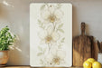 a picture of a flower on a wall next to a cutting board