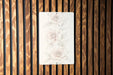a picture of some flowers on a wooden wall