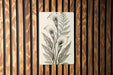 a picture of a flower on a wooden wall