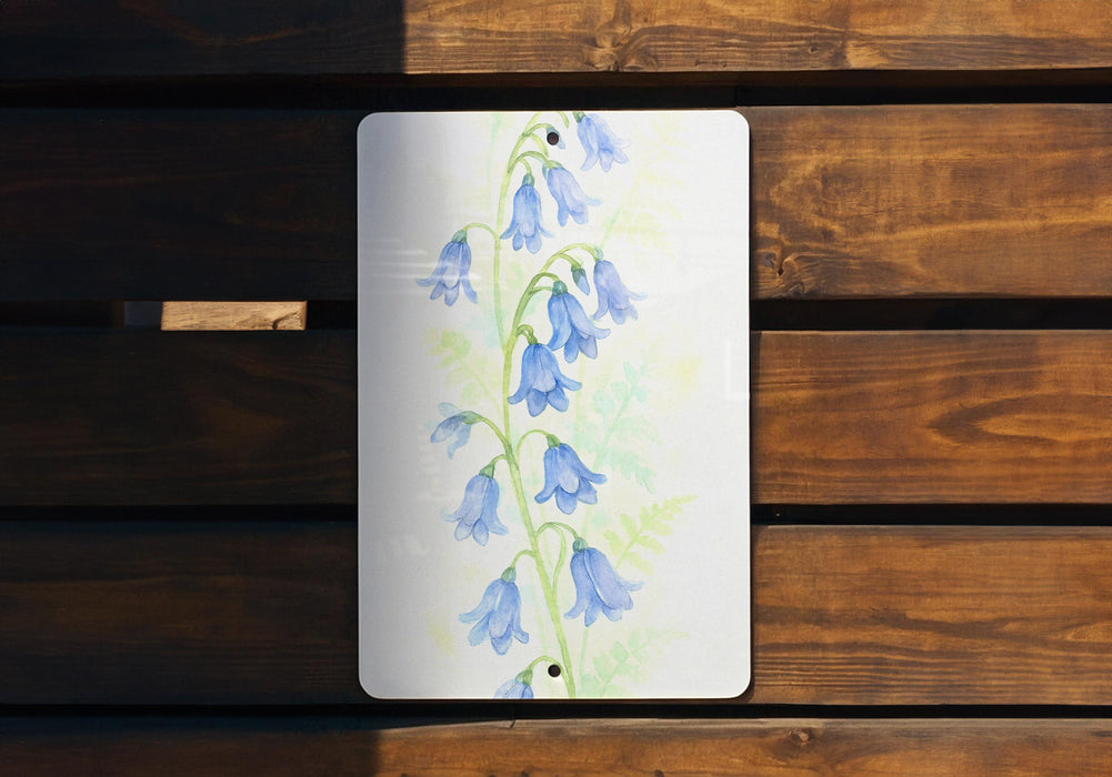 a painting of bluebells on a wooden bench