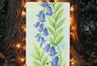 a painting of bluebells on a tree with a string of lights