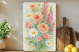 a painting of flowers on a shelf next to a potted plant