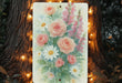 a painting of flowers is hanging on a tree