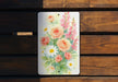 a painting of flowers on a wooden bench