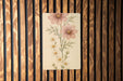 a picture of some flowers on a wooden wall