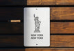 a new york sign on a wooden bench