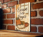 a sign that reads escape into pages on a brick wall