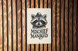 a raccoon sticker on a wooden wall
