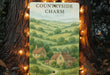 a picture of a country side charm hanging on a tree