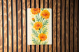a painting of orange flowers on a wooden wall
