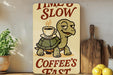 a wooden sign with a turtle holding a cup of coffee