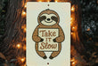 a sign that says take it slow on a tree