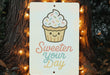 a sign that says sweeten your day hanging from a tree