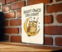 a night owl's delight sign on a brick wall