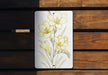 a painting of yellow flowers on a white plate