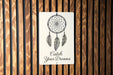 a wooden wall with a sign that says catch your dreams