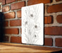 a picture of some flowers on a brick wall