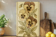 a painting of flowers on a wall next to a potted plant