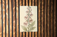 a picture of a flower on a wooden wall