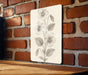 a picture of a flower on a brick wall