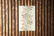 a picture of a flower on a wooden wall