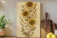 a painting of sunflowers on a wall next to a cutting board