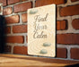 a sign that says find your calm on a brick wall