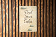 a sign on a wooden wall that says find your calm