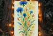a painting of blue flowers on a yellow background